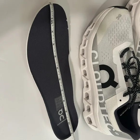 On Running White and Black Athletic Shoes with CloudTec Cushioning