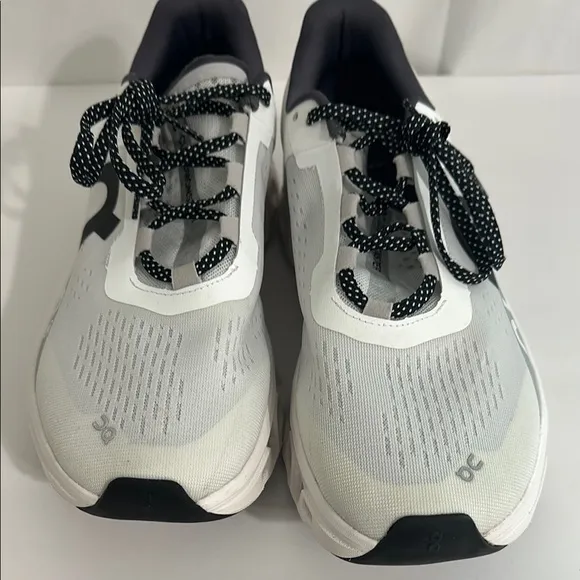 On Running White and Black Athletic Shoes with CloudTec Cushioning